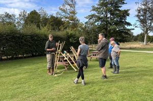 Doug Gooday, Scything trainer, delivering a scything workshop at Aden Country Park